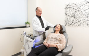 Co-founder Michael Johnson gently sprays CytoPeel's atomizer mist on a female patient's face. This CytoSolution promotes a smooth, quick recovery after a Hydrafacial near Champlin.
